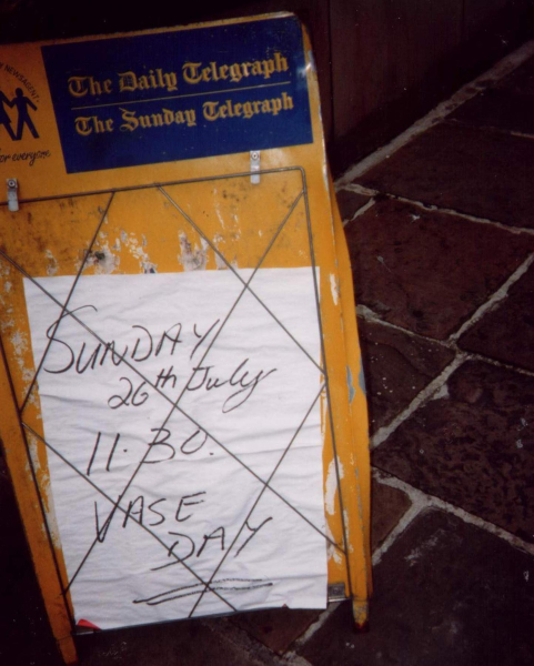 Poster advertising the arrival of the Tilted Vase 
17-Buildings and the Urban Environment-05-Street Scenes-017-Market Place
Keywords: 1998