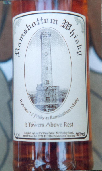 Ramsbottom Whisky bottle label: Leachs Wine cellar Shuttle 1996. Label- Holcombe Tower centrepiece with 'Thats nowt's1 frisky as Ramsbottom Whisky. It Towers above Rest' 
03 - Shops, Restaurants & Hotels - 02 - Individual shops
Keywords: Bury-Archive