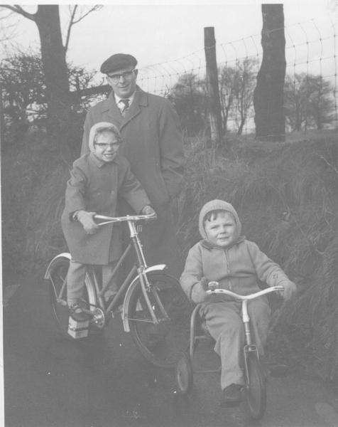 Alan, John & Claire Hibbert, 1964 Nuttall Lane Ramsbottom. Children with Christmas-present  bikes.   (One small  normal bicycle, other 3-wheeled toy trike]  digitised
09 - People and Family - 01 - Families
Keywords: Bury-Archive