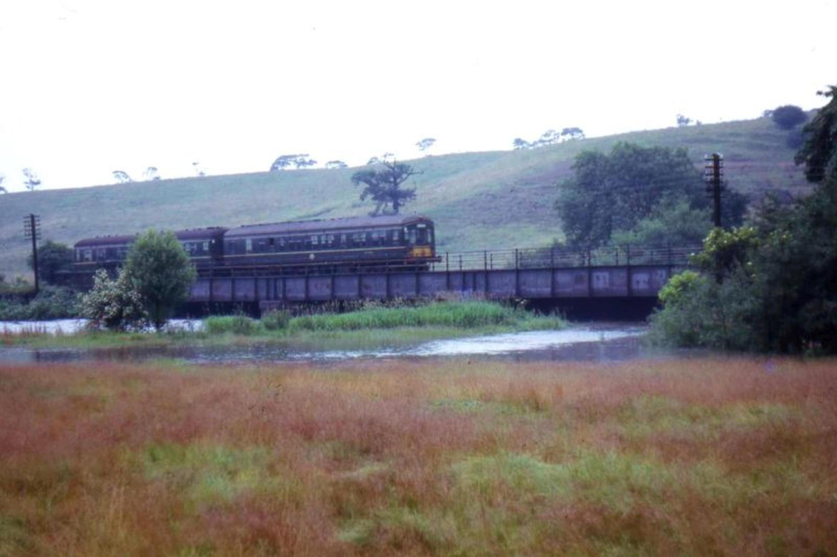 August Bank Holiday weekend 1964 â€“ a DMU crossing the Irwell south of Ramsbottom, unaffected by the rising flood water.
16 - Transport - 03 - Trains and Railways
Keywords: Bury-Archive